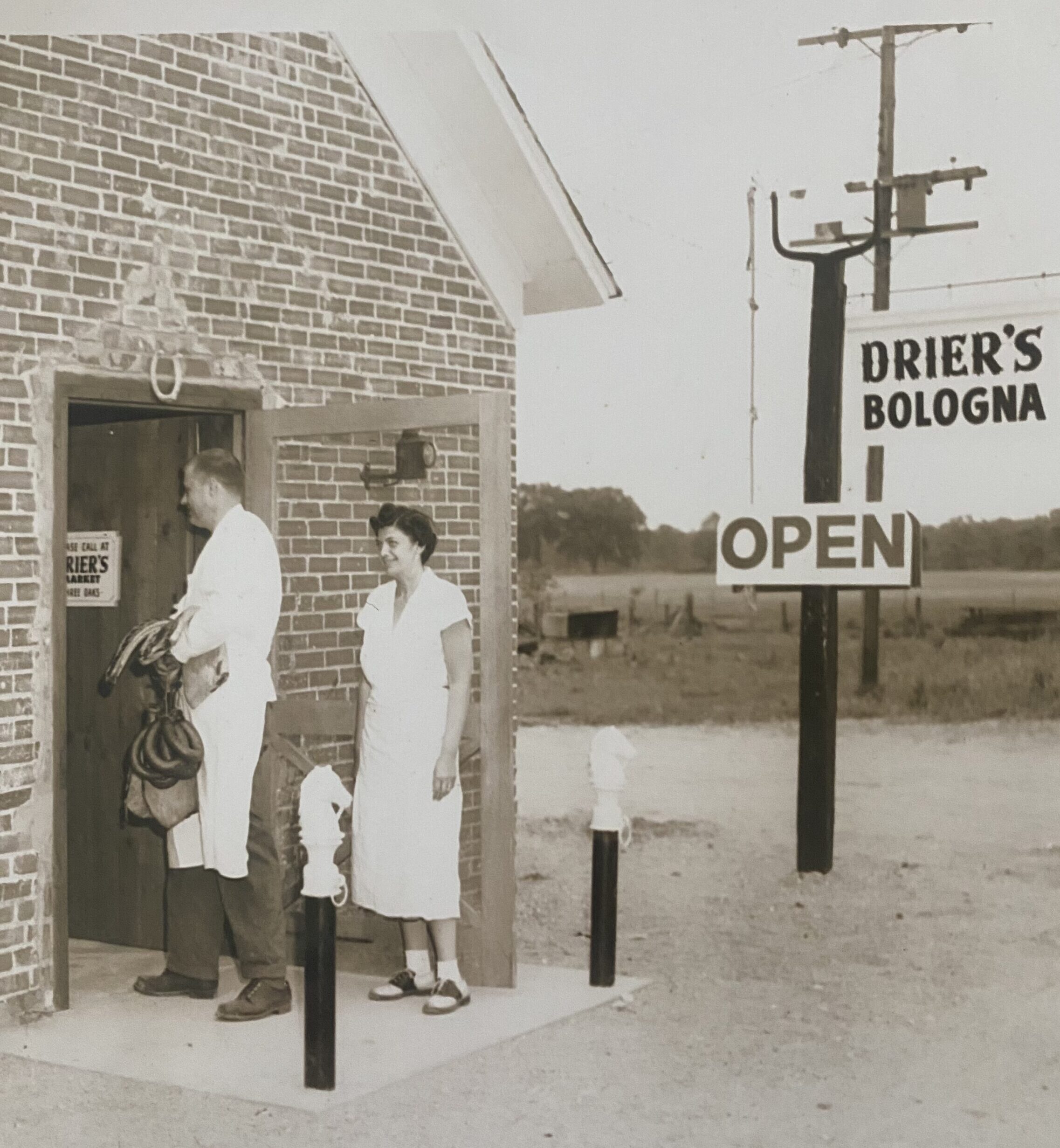 Black-and-white photo of the Drier's Meat Market storefront with a Drier's Bologna sign