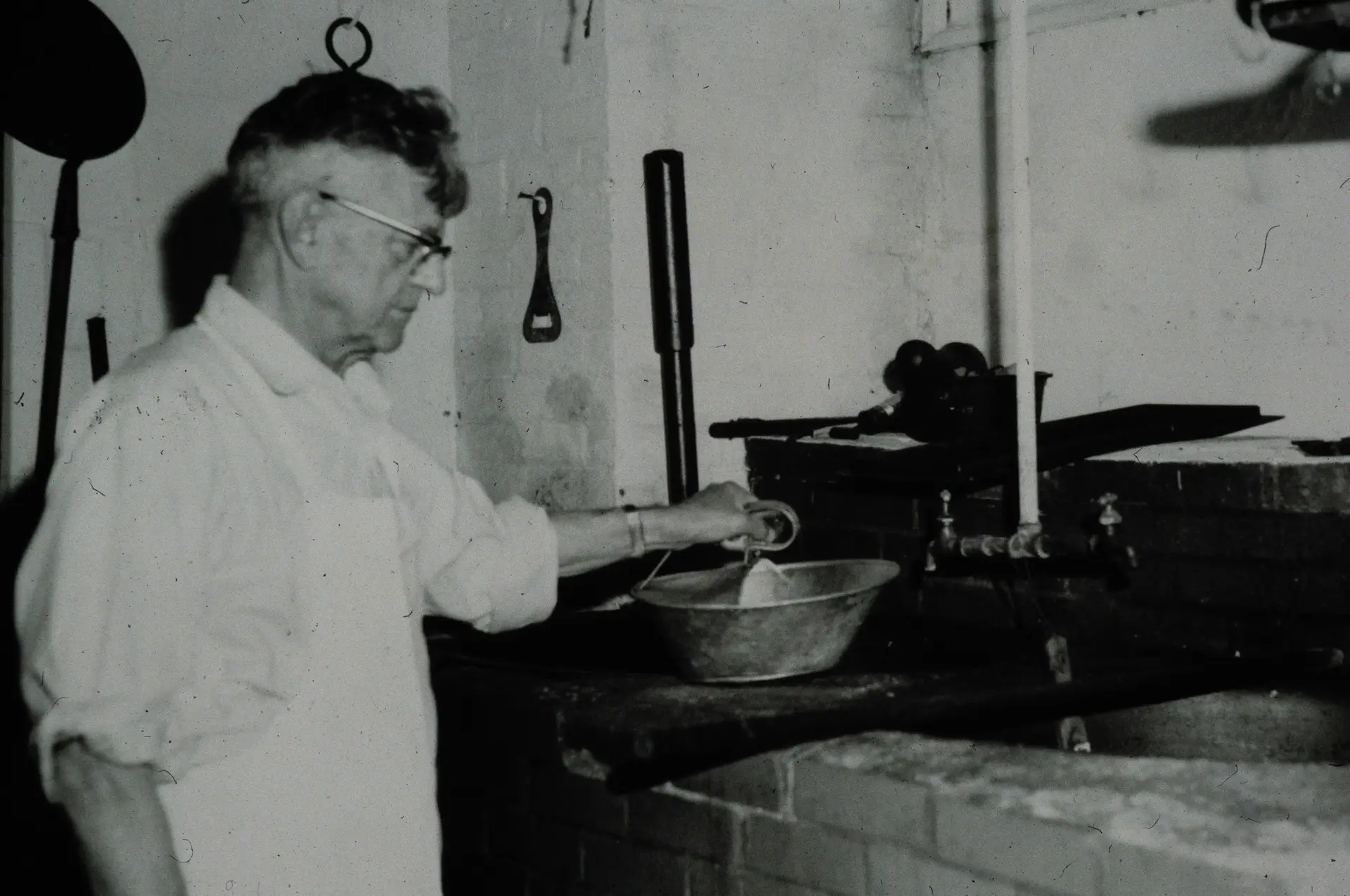 Black-and-white portrait of an older man indoors, part of the archival photo collection at Drier's Meat Market